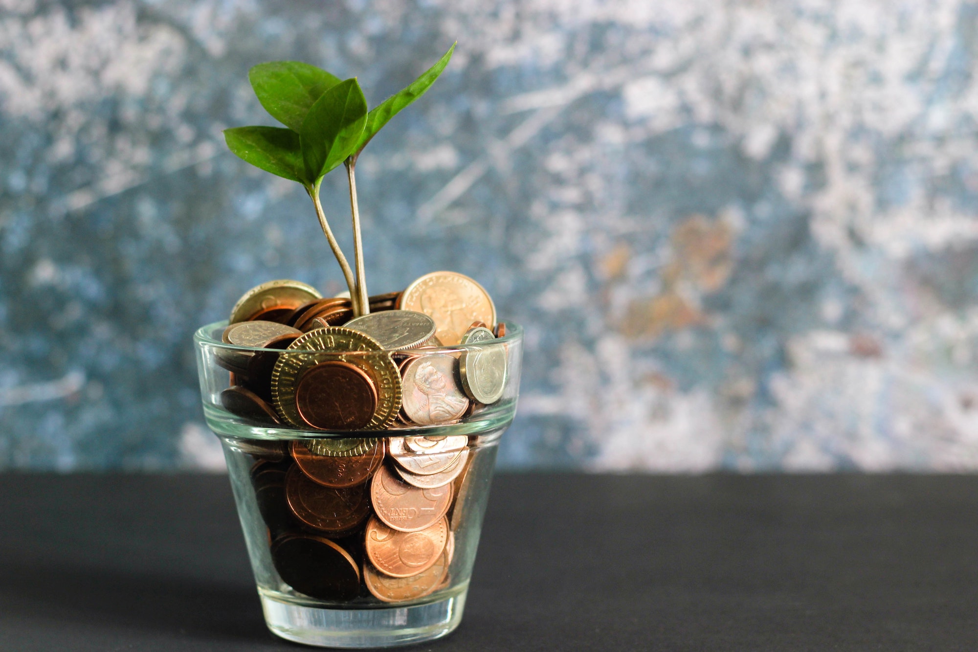Glass full of coins - Photo by Visual Stories || Micheile on Unsplash