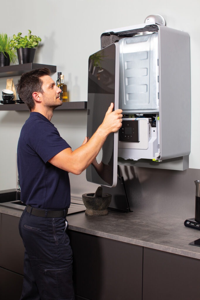 Gas engineer removing boiler case